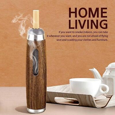Wooden vape device with smoke on a table with tea set, against a 'Home Living' branded background.